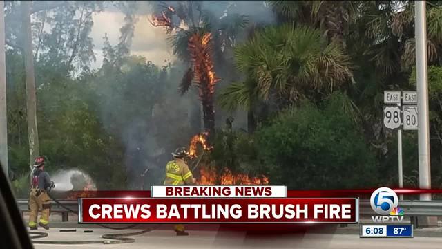 Crews monitor brush fire in suburban West Palm
